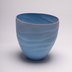 This contemporary blue ceramic vase has an organic shape inspired by nature.