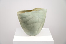 This contemporary ceramic vessel is moss green in color. Image 7