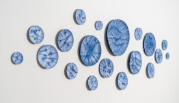 This contemporary horizontal wall composition by Paula Murray is composed of blue porcelain discs. Image 3