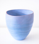 This contemporary blue ceramic vase has an organic shape inspired by nature. Image 2