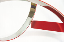 Four stainless steel rings, polished on the inside and matte red on the exterior, are curated into an elegant yet playful composition by Phi… Image 7