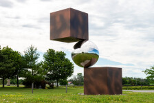 This contemporary outdoor metal sculpture is geometric in shape. Image 3