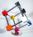 In this dynamic sculpture by Phillipe Pallafray, an open 3D stainless steel cube; each point connected by a brightly coloured solid cube in … Image 7