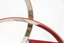 Four stainless steel rings, polished on the inside and matte red on the exterior, are curated into an elegant yet playful composition by Phi… Image 8