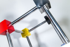 In this dynamic sculpture by Phillipe Pallafray, an open 3D stainless steel cube; each point connected by a brightly coloured solid cube in … Image 9