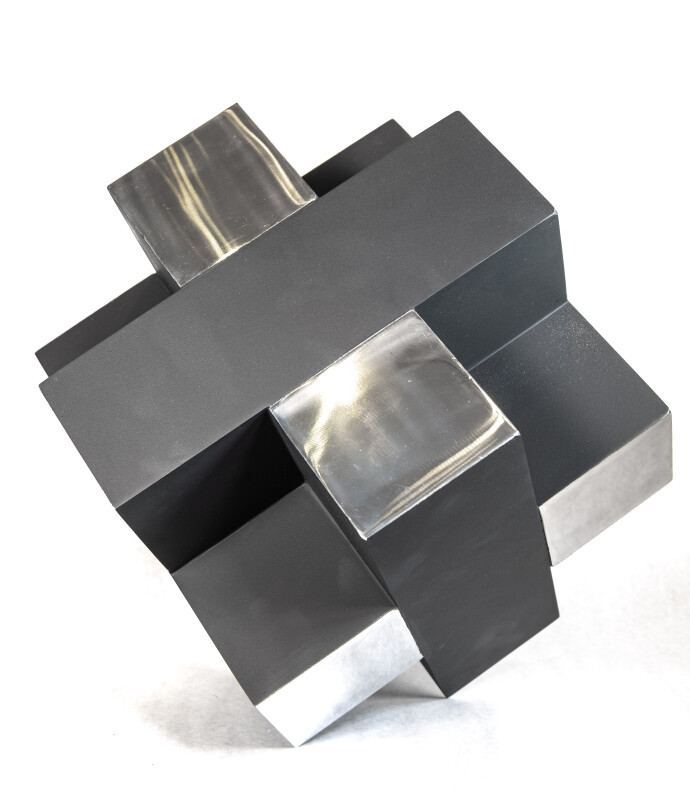 This contemporary table top metal sculpture of a black cube is by Philippe Pallafray.