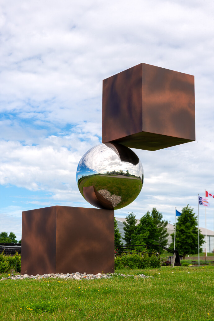 This contemporary outdoor metal sculpture is geometric in shape.