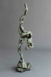 A ballet dancer on pointe—one leg raised high above her bowed head is captured in this dramatic bronze piece by Richard Tosczak. Image 2