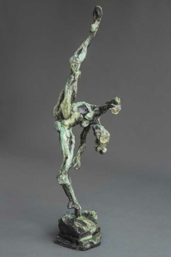 A ballet dancer on pointe—one leg raised high above her bowed head is captured in this dramatic bronze piece by Richard Tosczak.