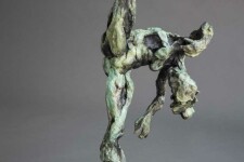 A ballet dancer on pointe—one leg raised high above her bowed head is captured in this dramatic bronze piece by Richard Tosczak. Image 6