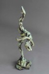 A ballet dancer on pointe—one leg raised high above her bowed head is captured in this dramatic bronze piece by Richard Tosczak. Image 3