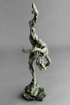 A ballet dancer on pointe—one leg raised high above her bowed head is captured in this dramatic bronze piece by Richard Tosczak. Image 5