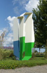 Reminiscent of the angles and form found in origami, this intriguing sculpture stands tall against the sky. Image 3