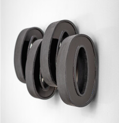 This contemporary wall sculpture by Rod Mireau is made of black wood and resin.