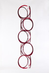 Slender rings of flattened candy red steel are stacked into an elegant yet playful column by master sculptor Shayne Dark. Image 3