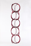 Slender rings of flattened candy red steel are stacked into an elegant yet playful column by master sculptor Shayne Dark. Image 2