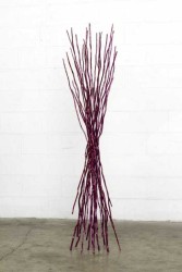 The bundled steel branches of this sculpture echo the patterns and movement of the natural world.