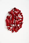 In a gorgeous candy coloured red, ribbons of steel swirl together curling and overlapping to form a circle. Image 6
