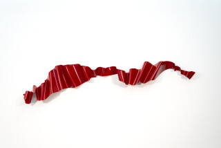 This contemporary wall sculpture is forged from steel and painted red.