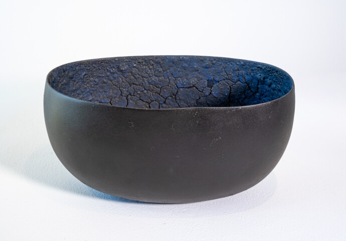 This contemporary ceramic black bowl that features an infinity loop is by Steven Heinemann.