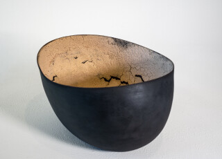 This contemporary ceramic black and melon coloured bowl is by Steven Heinemann.
