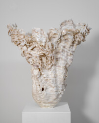 This contemporary sculptural indoor white porcelain vessel was made by Susan Collett.