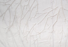 This unique embossed white print was inspired by nature and features tree imagery. Image 8