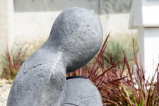 This figurative minimalist outdoor sculpture is made of concrete. Image 3