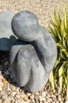This figurative minimalist outdoor sculpture is made of concrete. Image 6