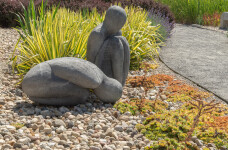 This figurative minimalist outdoor sculpture is made of concrete. Image 9
