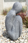 This figurative minimalist outdoor sculpture is made of concrete. Image 4