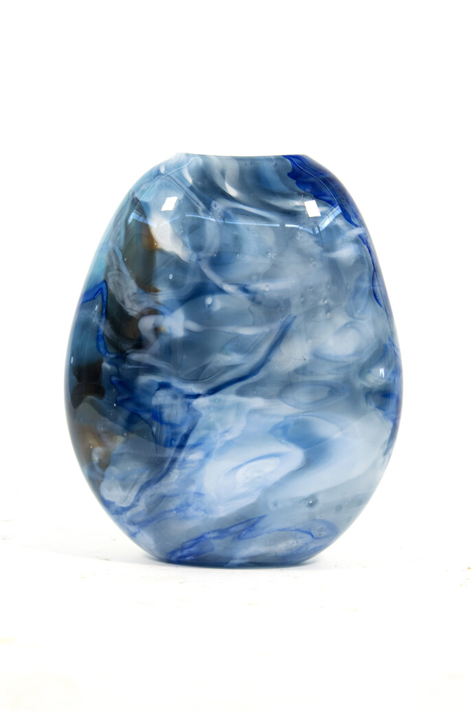 This beautiful swirling sky blue vessel in blown glass takes its organic shape and wild patterns from nature.