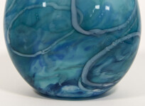 This beautiful aqua blue vessel in blown glass takes its organic shape and wild patterns from nature. Image 4