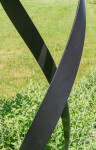 This contemporary outdoor minimalist steel sculpture features a globe. Image 6