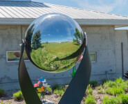 This contemporary outdoor minimalist steel sculpture features a globe. Image 9